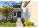 Charming home featuring a well-maintained lawn, lush landscaping, and a welcoming front entrance with double doors at 16626 Paynes Mill Dr, Lakewood Ranch, FL 34211