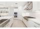 Modern kitchen with white cabinets, stainless steel appliances, and a gas range cooktop at 16626 Paynes Mill Dr, Lakewood Ranch, FL 34211