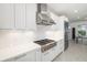 Well-lit kitchen showcasing stainless steel appliances, white cabinetry, and a modern gas range cooktop at 16626 Paynes Mill Dr, Lakewood Ranch, FL 34211