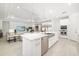 Bright, open-concept kitchen with a large island, modern appliances, and seamless flow to the living area at 16626 Paynes Mill Dr, Lakewood Ranch, FL 34211