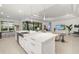 Spacious kitchen with a large island, stainless steel sink, modern lighting, and an open floor plan at 16626 Paynes Mill Dr, Lakewood Ranch, FL 34211