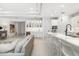Open-concept living area with a sleek kitchen, comfortable seating, and stylish decor at 16626 Paynes Mill Dr, Lakewood Ranch, FL 34211