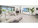 Cozy living room with sectional sofa, glass table, large windows, and views of the backyard at 16626 Paynes Mill Dr, Lakewood Ranch, FL 34211