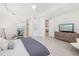Bright main bedroom featuring light wood floors, ample space, and minimalist decor at 16626 Paynes Mill Dr, Lakewood Ranch, FL 34211