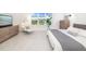 Inviting main bedroom with a view of the backyard, including modern furnishings and neutral decor at 16626 Paynes Mill Dr, Lakewood Ranch, FL 34211