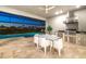 Outdoor kitchen and dining area next to a screened in pool with a pond view at 16626 Paynes Mill Dr, Lakewood Ranch, FL 34211