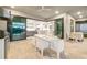 Outdoor dining area with kitchen and stainless grill overlooking the interior at 16626 Paynes Mill Dr, Lakewood Ranch, FL 34211