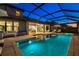 Back of the house with a private screened-in pool and spa, complemented by outdoor seating and a covered patio at 16626 Paynes Mill Dr, Lakewood Ranch, FL 34211
