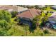 Aerial view showcases a home with a screened lanai, pool and well-maintained landscaping and tile roof at 21287 Sandal Foot Dr, Venice, FL 34293