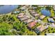 Beautiful aerial view of homes in a desirable community near a lake with mature landscaping and community pool at 21287 Sandal Foot Dr, Venice, FL 34293