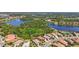 Scenic aerial view of lakeside homes and community with mature trees and landscaping at 21287 Sandal Foot Dr, Venice, FL 34293