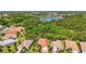 Beautiful aerial view of a home with mature landscaping in a desirable community near a lake at 21287 Sandal Foot Dr, Venice, FL 34293