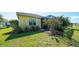 Grassy backyard and screened patio provide the perfect outdoor living space with a peaceful view at 21287 Sandal Foot Dr, Venice, FL 34293