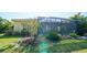A peaceful backyard with screened lanai, patio, and grassy lawn for outdoor enjoyment at 21287 Sandal Foot Dr, Venice, FL 34293