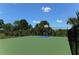 Well-maintained basketball court surrounded by lush greenery, providing a recreational amenity for active residents at 21287 Sandal Foot Dr, Venice, FL 34293