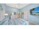 Bedroom with white furniture and decorations and a large TV at 21287 Sandal Foot Dr, Venice, FL 34293