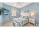 Cozy bedroom with TV, ceiling fan, and bedside tables at 21287 Sandal Foot Dr, Venice, FL 34293