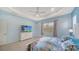 Charming bedroom featuring a large bed, a dresser with a TV, and lots of natural light at 21287 Sandal Foot Dr, Venice, FL 34293