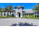 Elegant clubhouse featuring stone accents, blue shutters, and well-manicured landscaping at 21287 Sandal Foot Dr, Venice, FL 34293