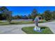 A fun, colorful dolphin statue on a manicured lawn highlights this community's artistic vibe at 21287 Sandal Foot Dr, Venice, FL 34293