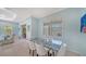 Dining room with a glass table and comfortable seating with views to the Gathering room and backyard at 21287 Sandal Foot Dr, Venice, FL 34293