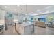 Open-concept kitchen with a large island, stainless steel appliances, and seamless view to living room at 21287 Sandal Foot Dr, Venice, FL 34293