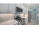 Modern kitchen featuring stainless steel appliances, white cabinets, and sleek countertops for easy cooking at 21287 Sandal Foot Dr, Venice, FL 34293