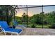 Charming screened lanai with lounge chairs, providing a peaceful spot to enjoy the beautiful sunset at 21287 Sandal Foot Dr, Venice, FL 34293