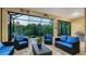 Screened-in lanai with comfortable seating and a view of lush greenery at 21287 Sandal Foot Dr, Venice, FL 34293