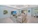 Open floor plan combining living and dining areas with modern furnishings and ample natural light at 21287 Sandal Foot Dr, Venice, FL 34293