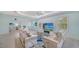 Bright living room featuring tile floors, modern sofas, recessed lighting, and tray ceiling at 21287 Sandal Foot Dr, Venice, FL 34293