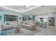 Inviting living space featuring tile floors, white sofas, and a sliding glass door leading to the outdoors at 21287 Sandal Foot Dr, Venice, FL 34293