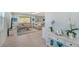 Open-concept living room with comfortable sofas, tile flooring, and sliding glass doors to the lanai at 21287 Sandal Foot Dr, Venice, FL 34293