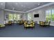 Bright meeting room with large windows, comfortable seating, and a modern aesthetic for social events at 21287 Sandal Foot Dr, Venice, FL 34293