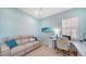 Comfortable home office with a modern desk, stylish decor, and a sofa at 21287 Sandal Foot Dr, Venice, FL 34293