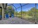 This relaxing screened patio features brick pavers, lounge chairs, and peaceful backyard views at 21287 Sandal Foot Dr, Venice, FL 34293
