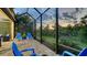 Enjoy evening sunsets on this screened patio with brick pavers, comfortable chairs and privacy at 21287 Sandal Foot Dr, Venice, FL 34293