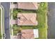 Aerial shot of a single Gathering home with a tile roof, green lawn, and situated on a lake at 2212 Weaver Bird Ln, Venice, FL 34292