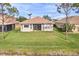 Backyard of home offers a beautiful lawn and view of the water at 2212 Weaver Bird Ln, Venice, FL 34292