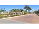 Landscaped entrance to a community with manicured gardens at 2212 Weaver Bird Ln, Venice, FL 34292