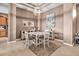 Cozy dining area illuminated by a chandelier, complemented by neutral walls and tile flooring at 2212 Weaver Bird Ln, Venice, FL 34292