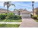 Charming single-story home featuring a beautiful tile roof, paver driveway, and well-manicured landscaping at 2212 Weaver Bird Ln, Venice, FL 34292