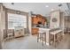 Well-lit kitchen featuring wood cabinets, breakfast bar, and tile floors creating a functional space at 2212 Weaver Bird Ln, Venice, FL 34292