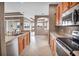 Stylish kitchen featuring wood cabinets, a sink overlooking the backyard, and tile flooring at 2212 Weaver Bird Ln, Venice, FL 34292