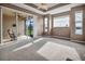 Spacious main bedroom featuring plush carpeting, tray ceilings, and a sliding door to the patio at 2212 Weaver Bird Ln, Venice, FL 34292