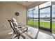 Relax on the screened-in patio with chairs and enjoy views of the lake at 2212 Weaver Bird Ln, Venice, FL 34292