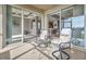 Comfortable patio with seating area and views into the living area and kitchen at 2212 Weaver Bird Ln, Venice, FL 34292