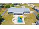 Aerial view of the backyard featuring a pool, lounge area, and well-maintained landscaping in a residential neighborhood at 2220 Palm Ter, Sarasota, FL 34231