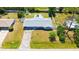 Aerial view of home with spacious yard, long driveway, and well manicured landscaping at 2220 Palm Ter, Sarasota, FL 34231