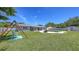 Expansive backyard with well manicured lawn, swingset, and inviting pool area at 2220 Palm Ter, Sarasota, FL 34231